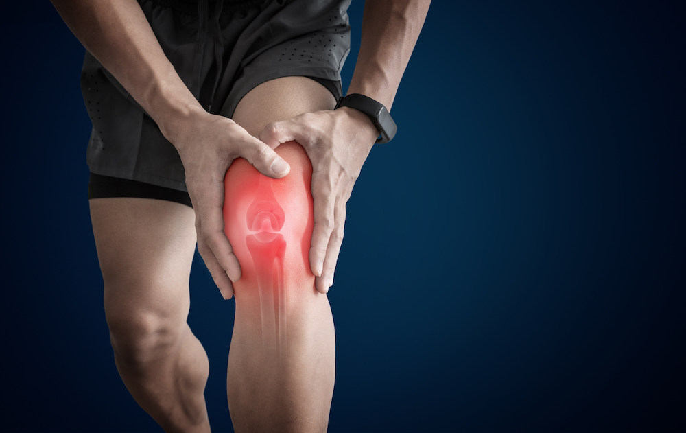 a man holding his overuse knee pain