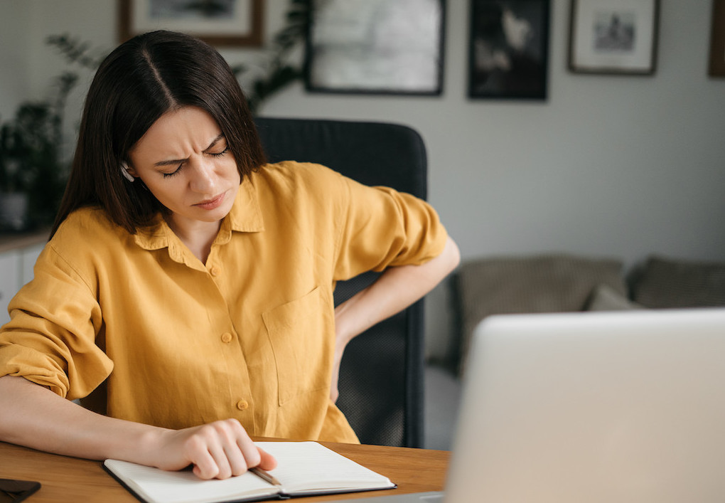 a woman having a bad posture back pain